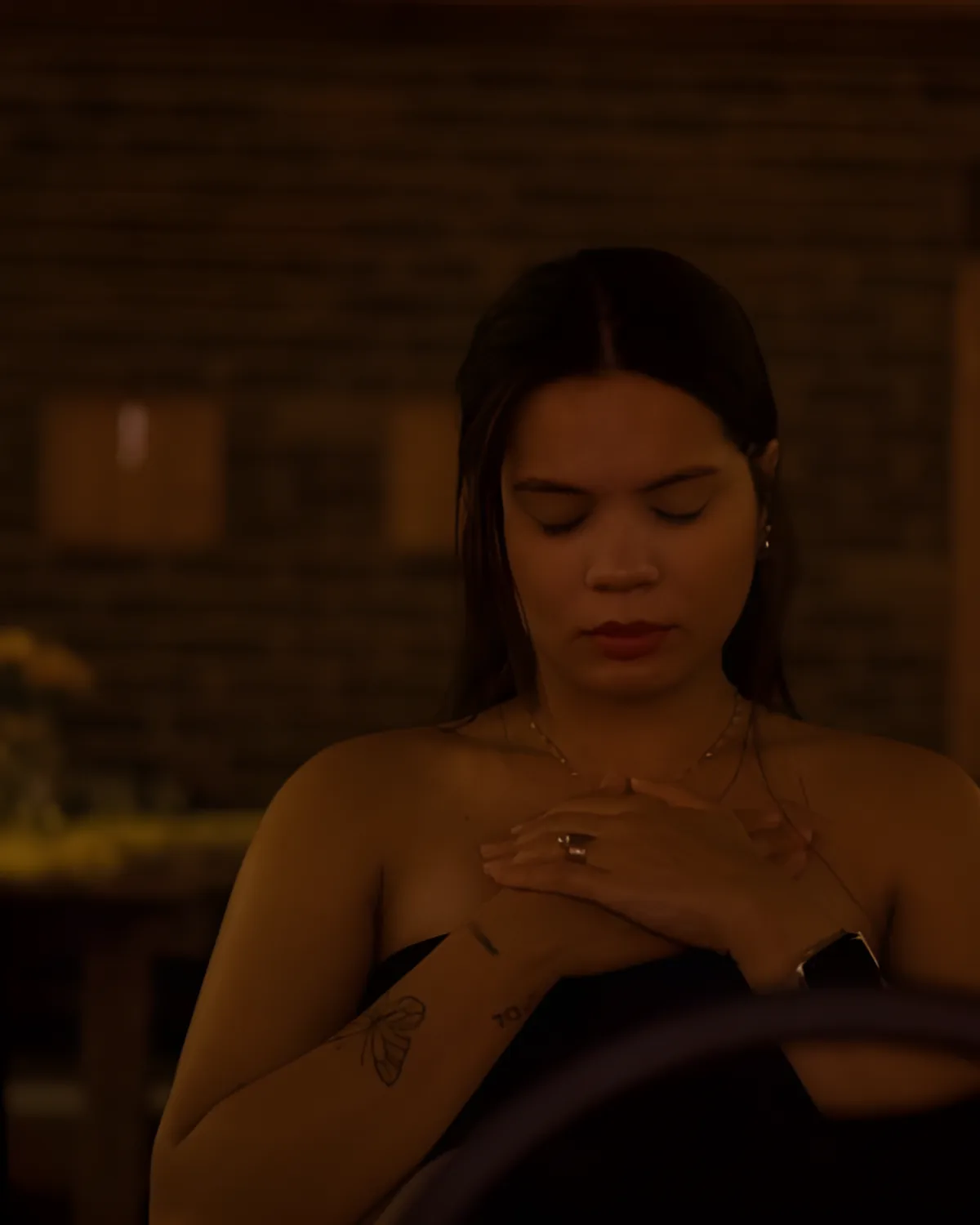 A woman prays in warm light at an Accepted Ladies night