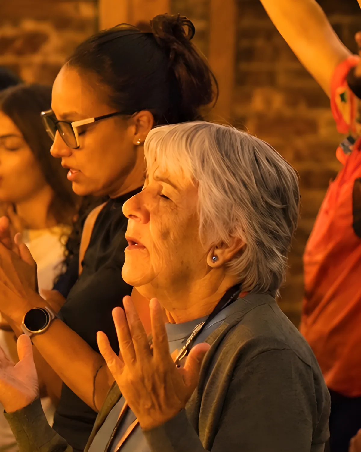 People worshipping with their hands raised